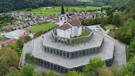 aerial drone shot of a church on a hill with mountains in the background, 4k uhd