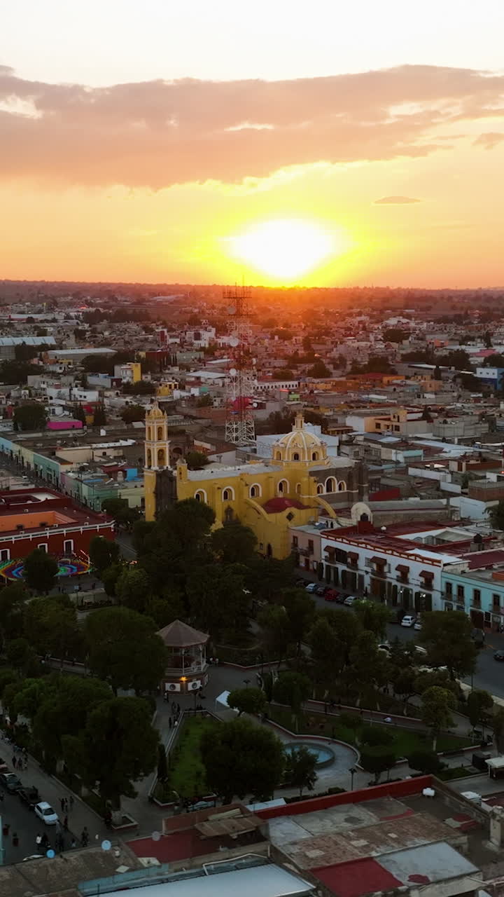 Vertical drone shot circling the church in Huamantla, colorful sunset in Mexico