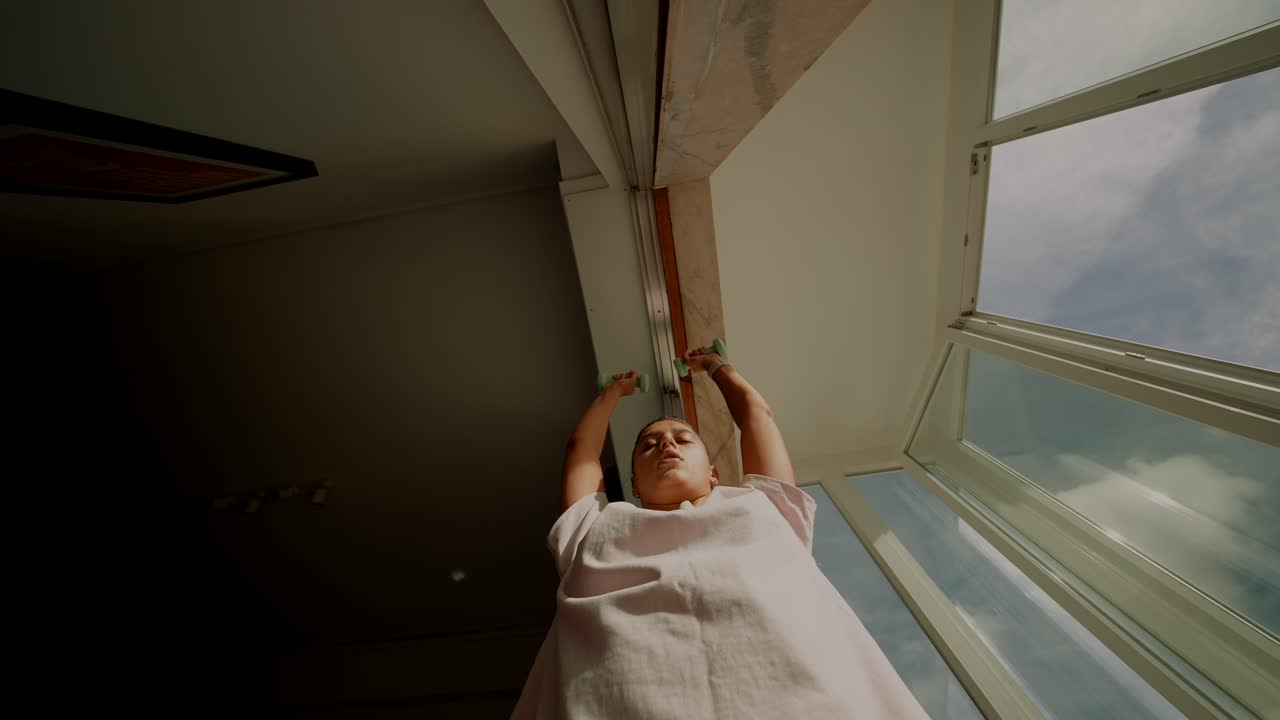 Woman Exercising with Dumbbells Indoors