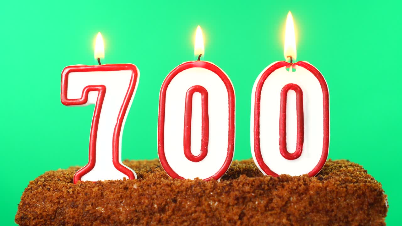 Cake with the number 700 lighted candle. Chroma key. Green Screen. Isolated