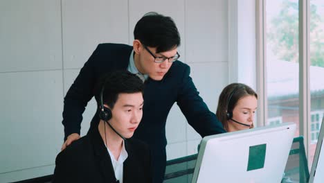 Business-people-wearing-headset-working-in-office