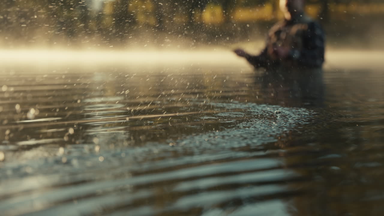 Fisherman in a misty morning river