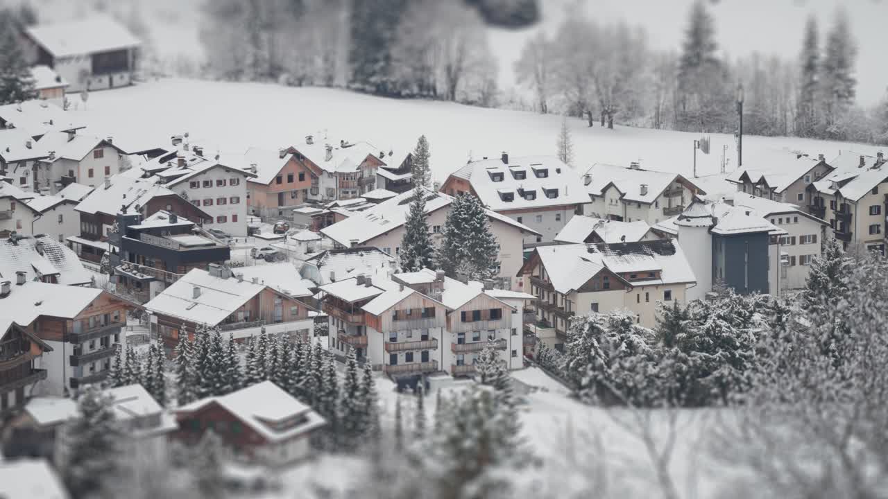 A picturesque winter village surrounded by snowy trees, nestled in the foothills of the Alps.