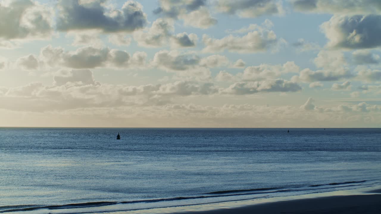 beautiful and romantic view of the sunset from seashore beach of the North sea with skyline horizon and sunlight with clouds