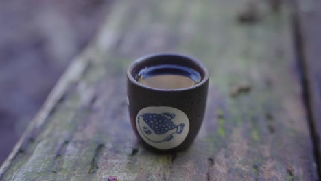 hot japanese sake  sitting on bench in mountains