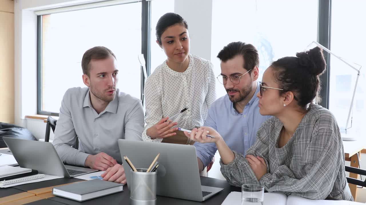 Smart skilled diverse colleagues analyzing marketing research results.