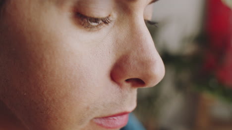 close up of transgender man applying pink lipstick