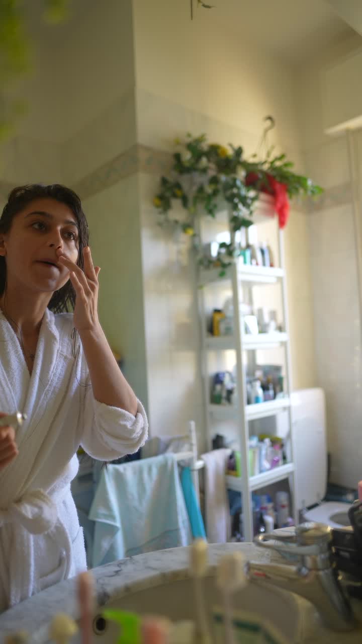 Woman Applying Skincare in Bathroom