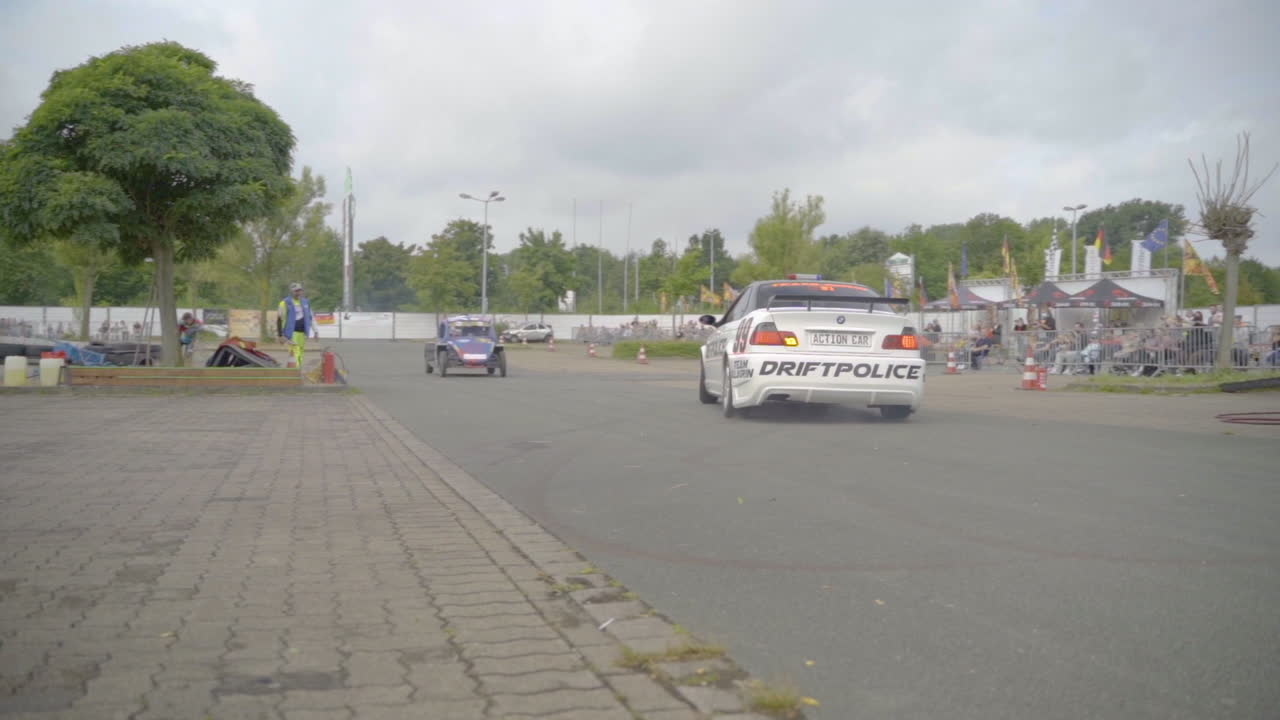 White Drift Car During A Stunt Show At The Arena In Germany. tracking shot, slow motion