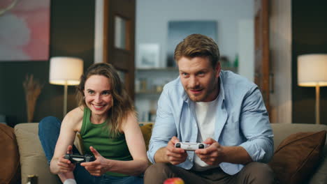 emotional gamers playing rpg video game. excited fun couple holding controllers