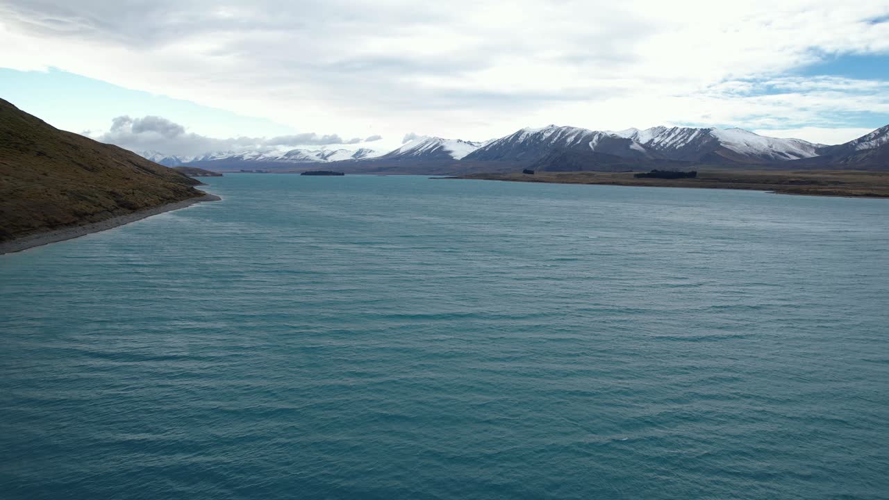 Aerial View Of Lake Tekapo With Snowy Mountain Range In The Background In South Island, New Zealand