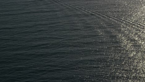 A-beautiful-vista-aérea-shot-over-a-boat-heading-out-to-oil-derricks-and-platforms-in-the-Santa-Barbara-Channel-California