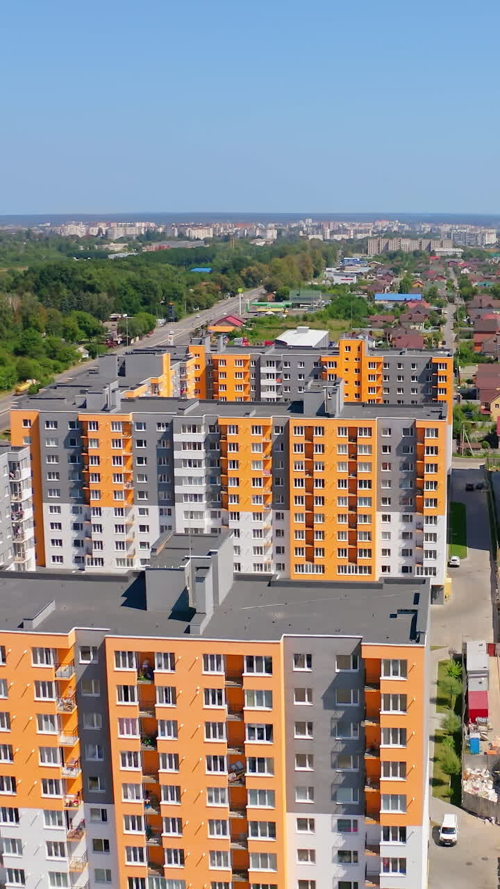 New district in the city. Contemporary buildings for residential purpose. High rise houses in the outskirts of the city. Aerial view. Vertical video