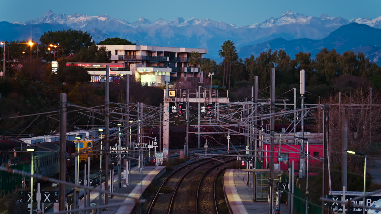 Antibes, France - January 25, 2025: Train station in Antibes with a distant view of the mountains in the evening