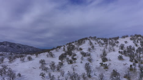 Mountain-covered-with-freshly-fallen-snow---aerial-push-in-view