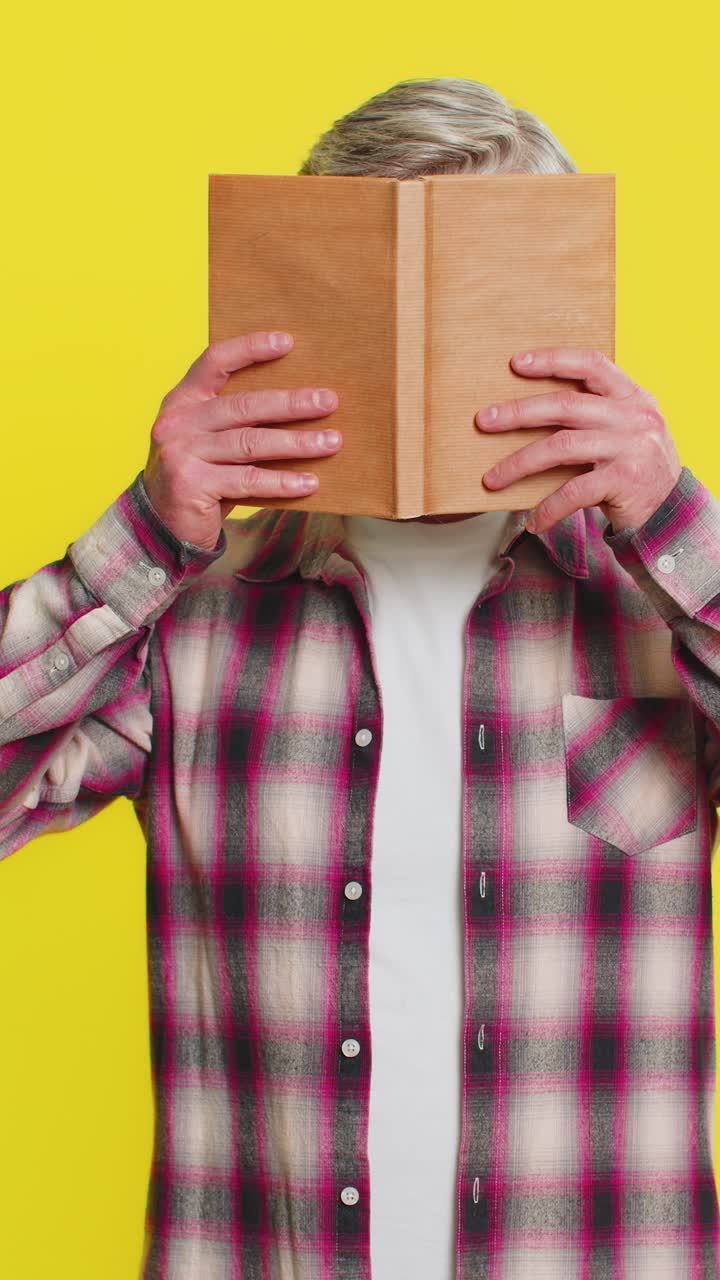 Зрелый мужчина открывает книгу удивленное лицо внезапное откровение мгновенный интерес удивительная история вибрация