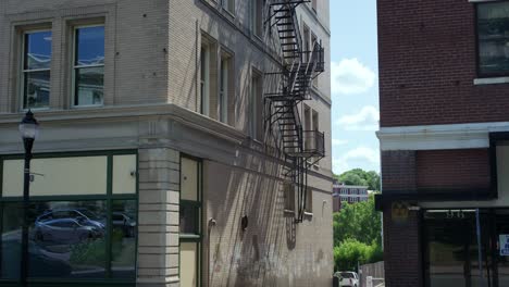 alleyway with a nuclear shelter sign on the corner of a brick building