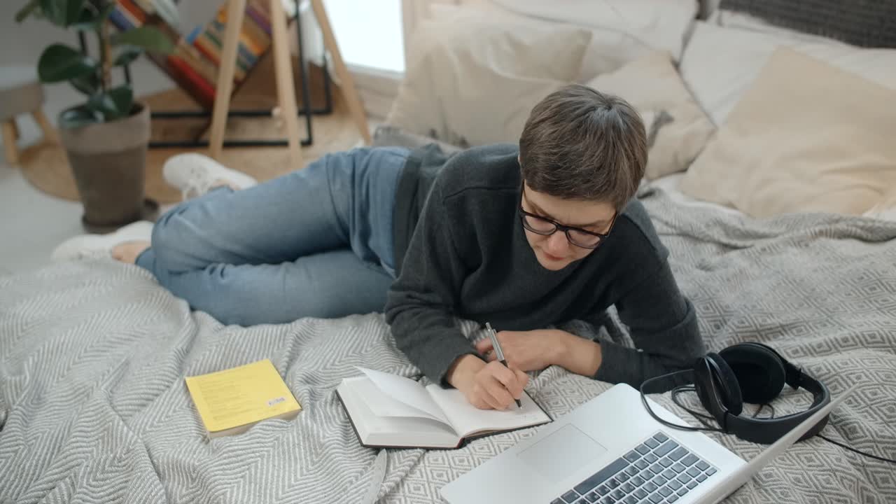 Student Studying Comfortably in Bed