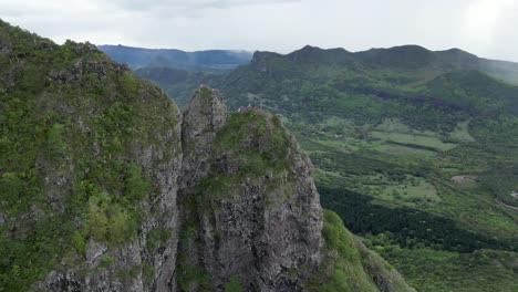 people on the mountain top in mauritius, aerial mountain landscape