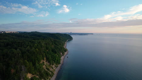 Aerial-Flying-Along-Orlowo-Cliffy-Coastline-With-Sandy-Beach-At-Stunning-Sunrise,-Gdynia-Poland