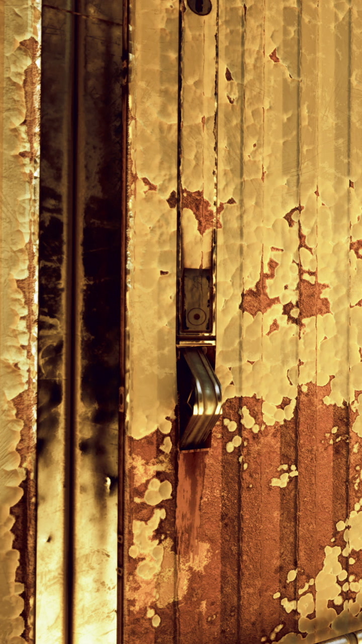 Details of a rusty lock on an old metal door in a city environment