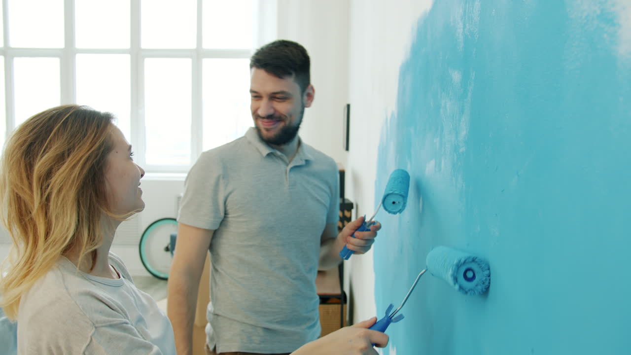 Couple Painting a Wall Blue