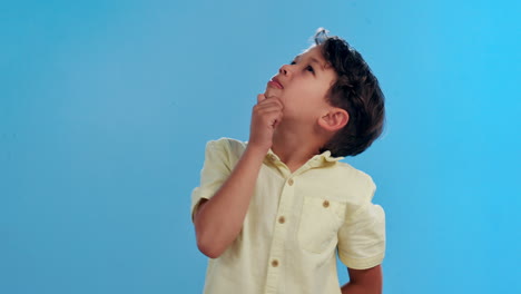 young boy thinking and looking up
