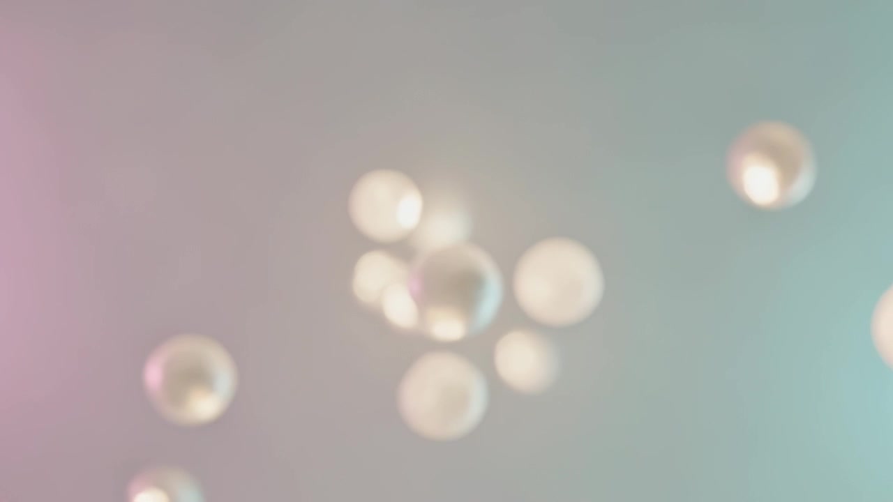 Drifting soap bubbles spreading as bubbles entering from sides on pastel backdrop, soft lighting