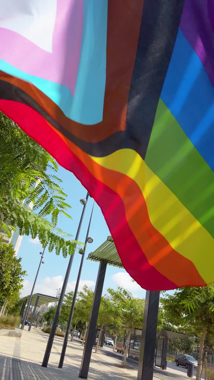 Progress Pride Colors flag in Motion on Sunny Day