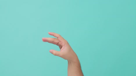 close up shot of human hand raising stretch out hand flicking off. unrecognized man showing hand gesture for language sign or symbol in isolate blue screen background with copy space for advertisement