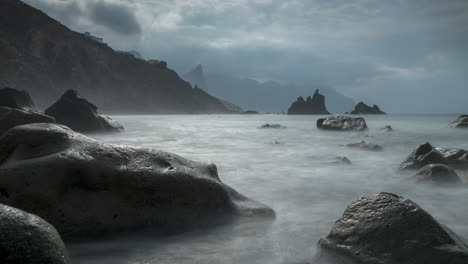 time lapse of clouds moving above coastline and misty atlantic ocean water