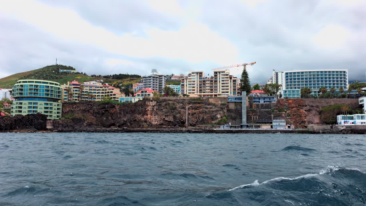 Coastline of Lido apartments and hotels, Madeira, as seen from the sea