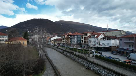 drone view of tetovo city along pena river, calm cityscape in balkans, a city with natural beauty