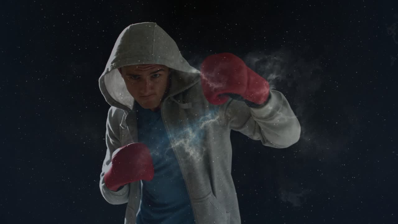 Male boxer starting guard, shifting and jabbing while nebula swirling over red gloves for fitness