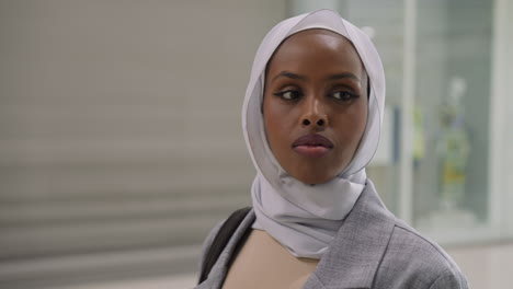 pretty black woman with hijab in modern shopping mall