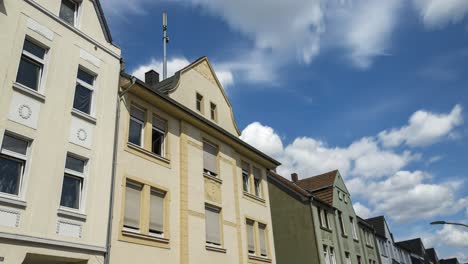 time lapse establishing shot, summer clouds over generic european street