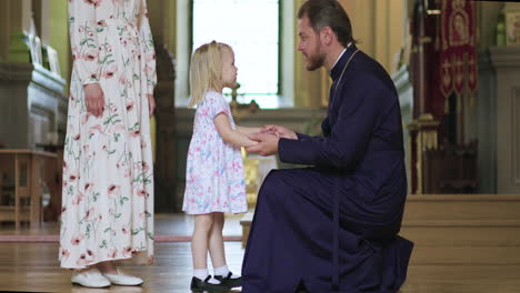 little child talking with priest