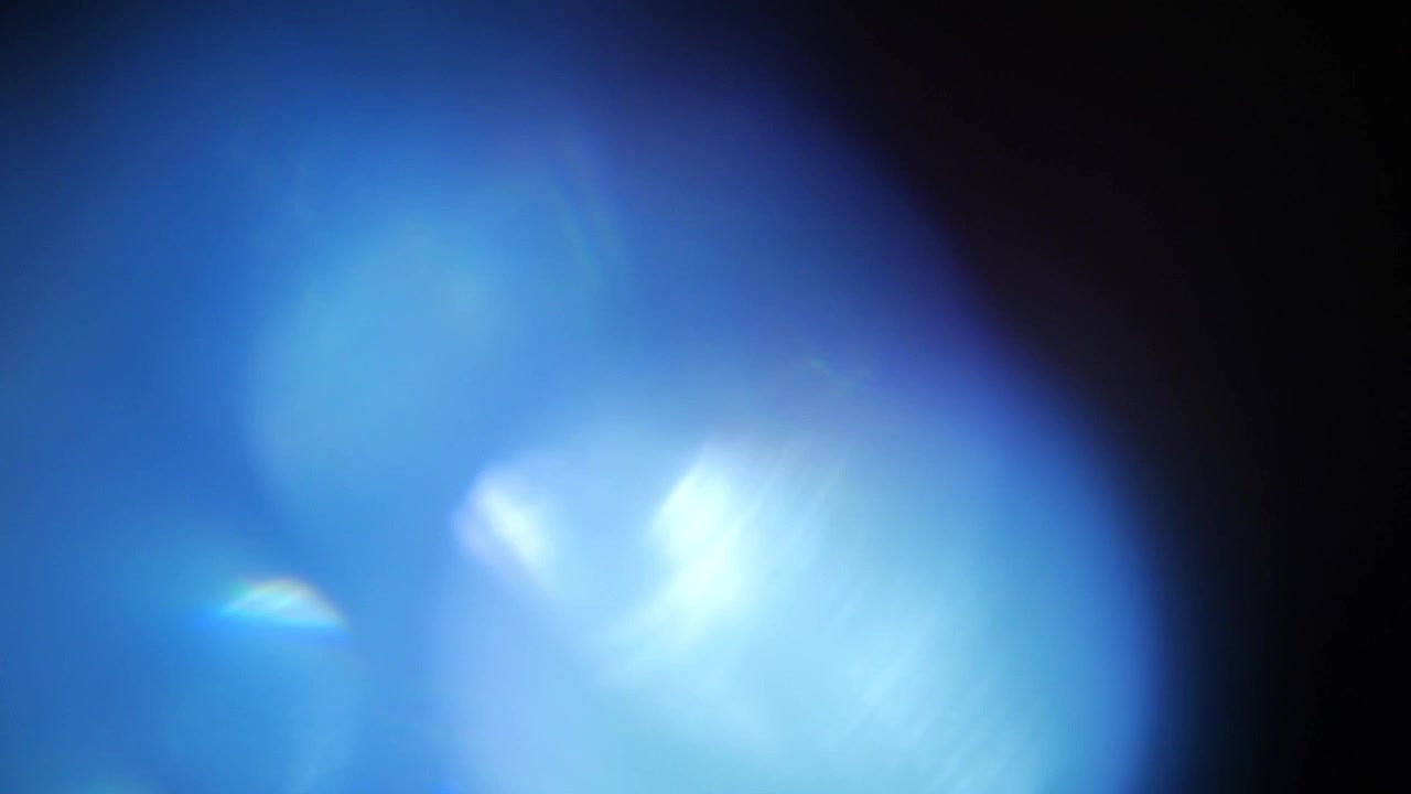 Effetto Luce Blu Brillante con Bagliore dell'Obiettivo su Sfondo Scuro