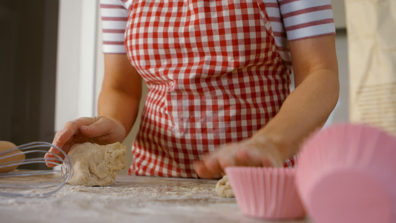 Woman forming balls with dough