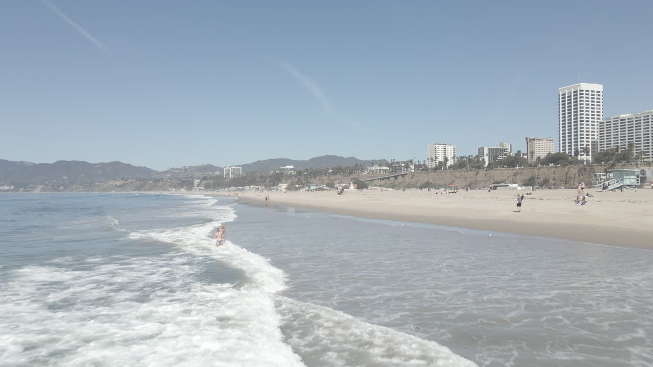Pacific Ocean seen by a drone just above the water as it heads towards Malibu