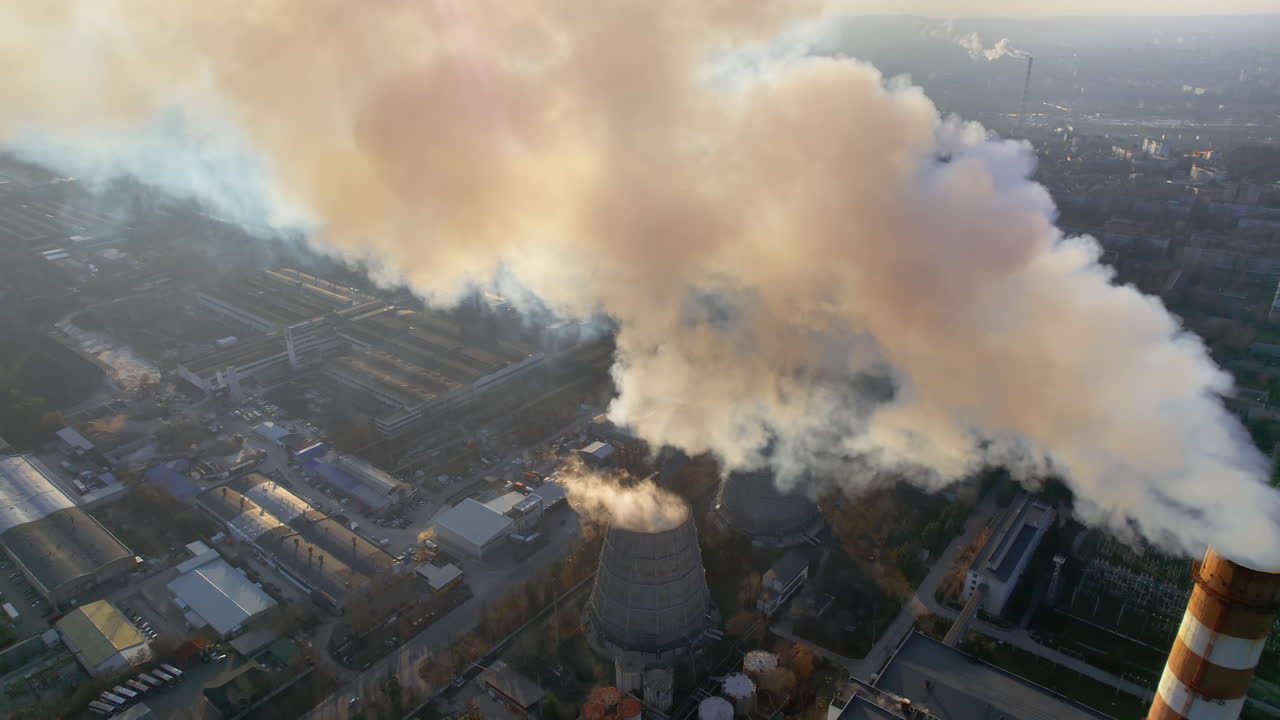 Aerial drone view of thermal power plant in Chisinau, Moldova. View of pipes with felling steam, cityscape