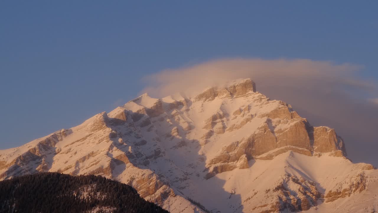 The beautiful, snow white mountain of Mt Cascade in Alberta, Canada - time lapse