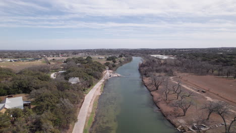 aerial view following the blanco river near blanco, texas in the hill country