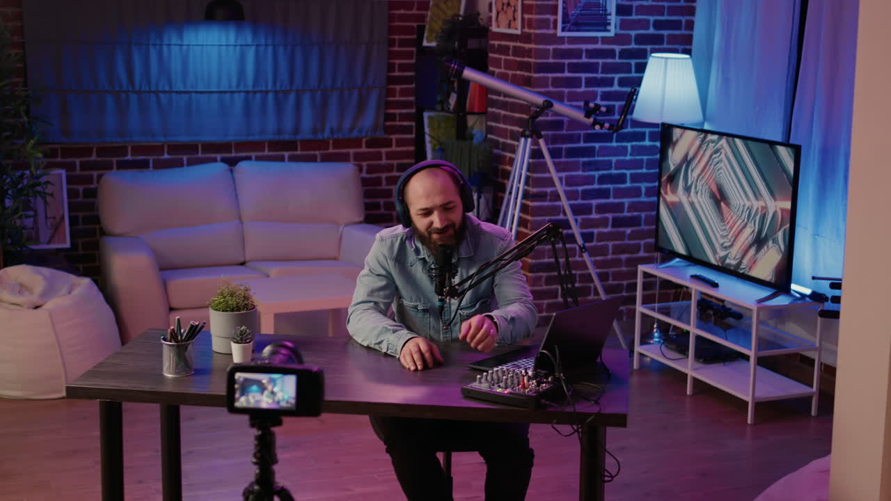 Male content creator recording vlog using digital video camera while using professional microphone