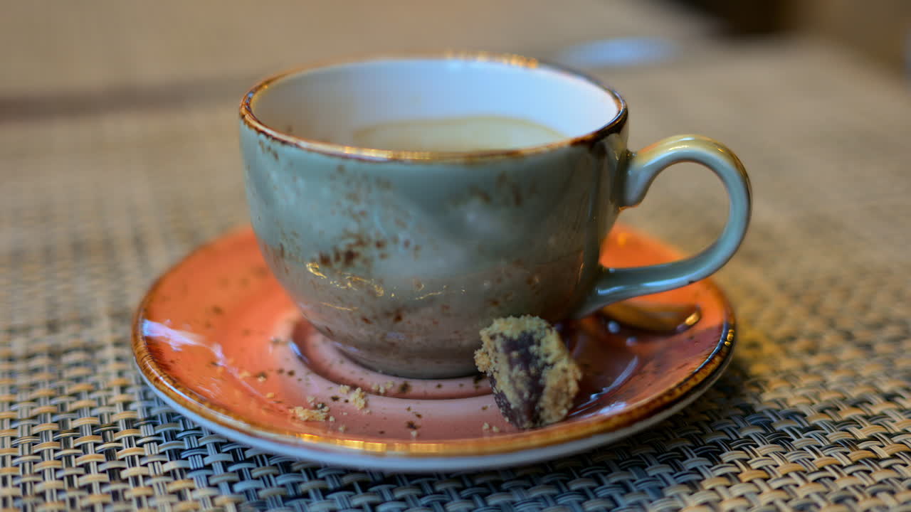 Cup of coffee in a ceramic mug in a rustic environment