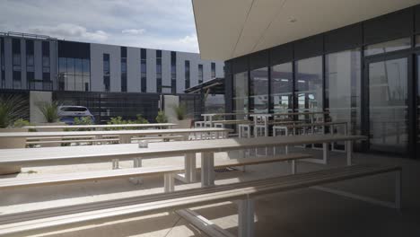slow motion shot of wooden benches outside a office for taking breaks