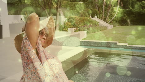 relaxing by pool, woman wearing hat and sunglasses with green bubbles animation