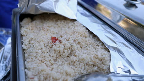 a large plate of rice at a barbecue party in the garden - pan right