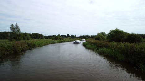 Aerial-Drone-4k-Footage-following-a-Boat-travelling-along-River-Yare,-Norfolk-Broads,-Norfolk