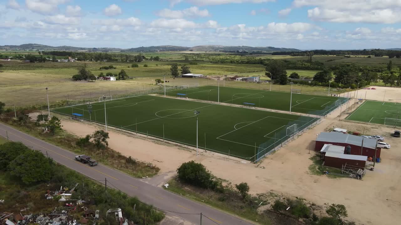 Multiple soccer fields dot the rural landscape, showcasing development and growth in sports infrastructure